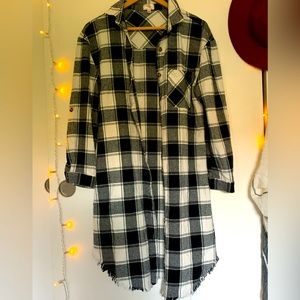 Plaid tunic/dress length button down. Features fringe hemline about 36” long